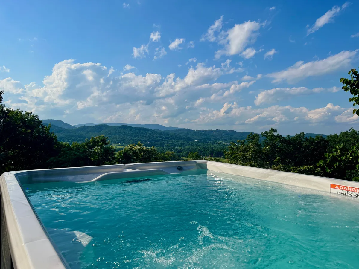 This image spotlights the outdoor swimming pool with a stunning mountain view and open sky—an on-site amenity that invites families, teens, and children to engage in fun activities together. The vibrant outdoor setting adds a layer of excitement and exploration to the lodge’s entertainment offerings.
